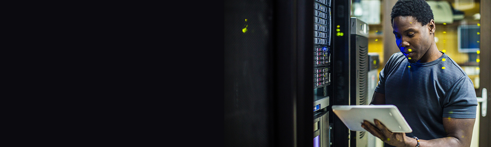 Person in data center holding a tablet