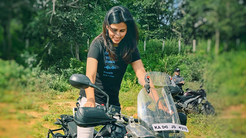 Person on a stationary motorcycle in nature.