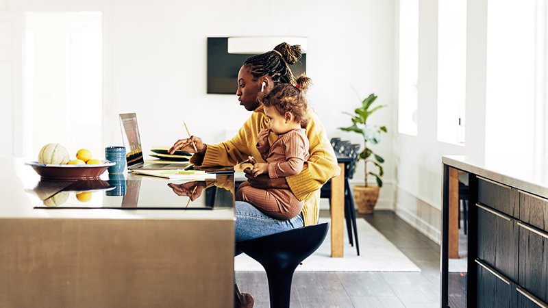 Patient having telehealth consultation with child on lap