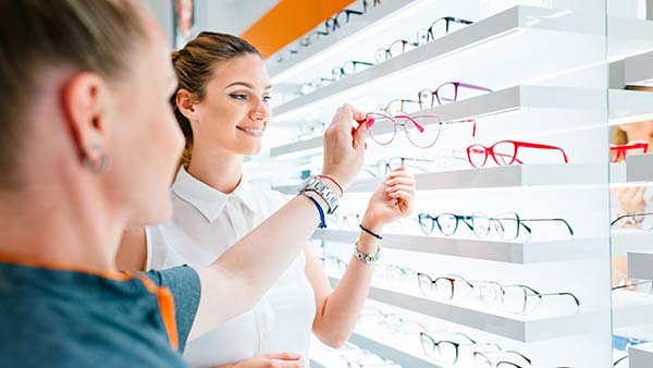 Two customers trying on glasses at Visionworks