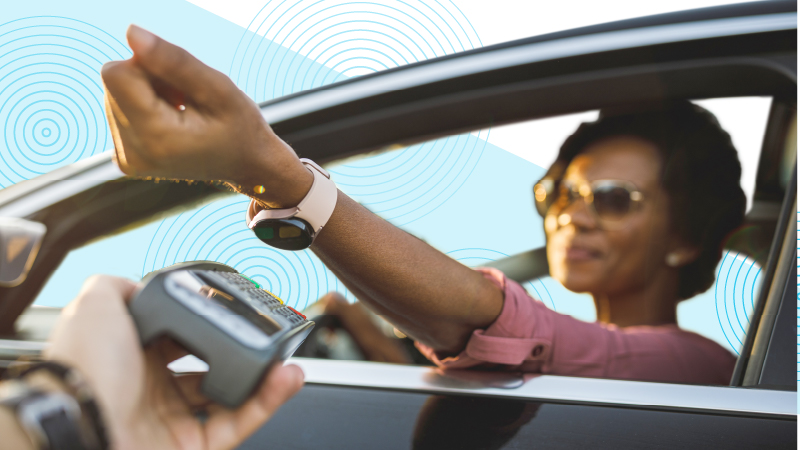 Car driver paying for a drive-through order using a smart watch 