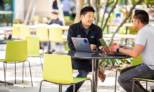 Image of two people talking at a table