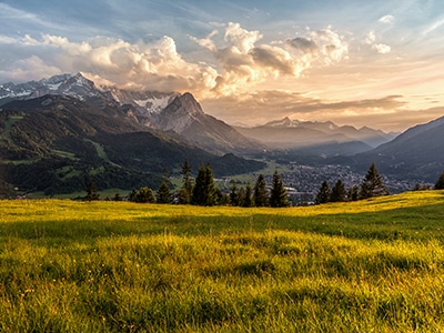 Image of a field with mountains and sky in the background