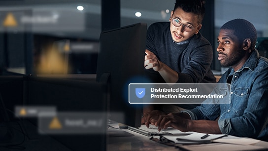 two men looking at a monitor together with Distributed Exploit Protection Recommendation text over image