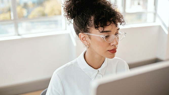 IT professional in an office at a workstation