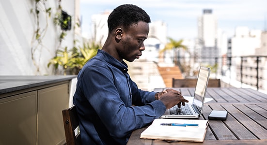 Man working on laptop outside